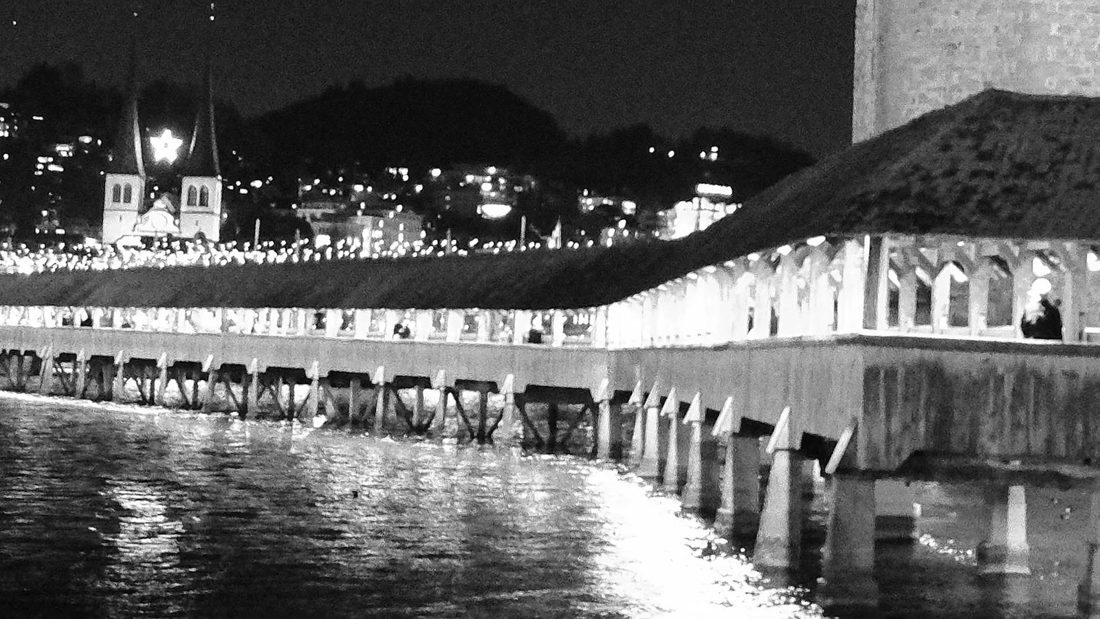 Black and white night view of Lucerne Chapel Bridge over the Reuss river