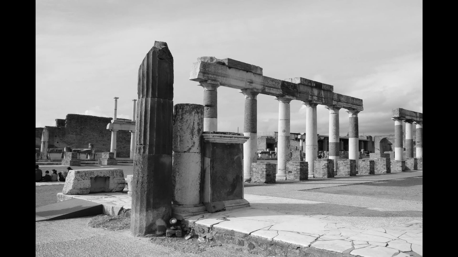 Black and white photo of the columns of the Forum in Pompeii