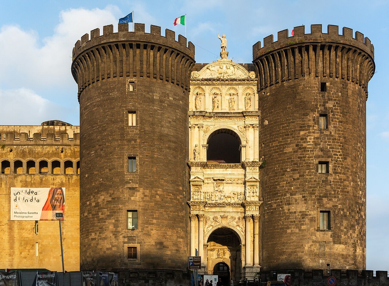 Castel Nuovo in Naples: two round stone towers flanking a white marble Renaissance triumphal arch over the entrance