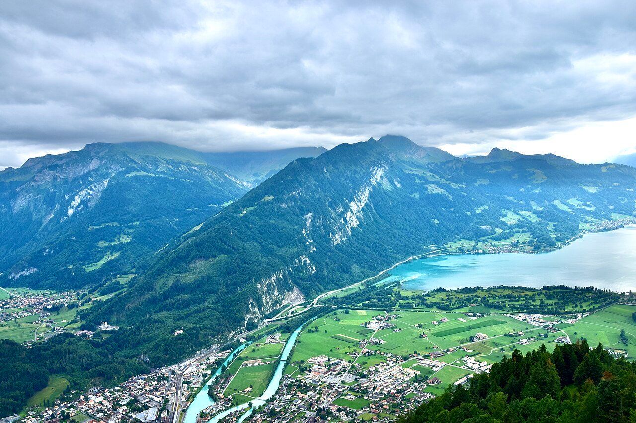 Interlaken and the Aare seen from Harder Kulm, with Lake Thun stretching away between the mountains