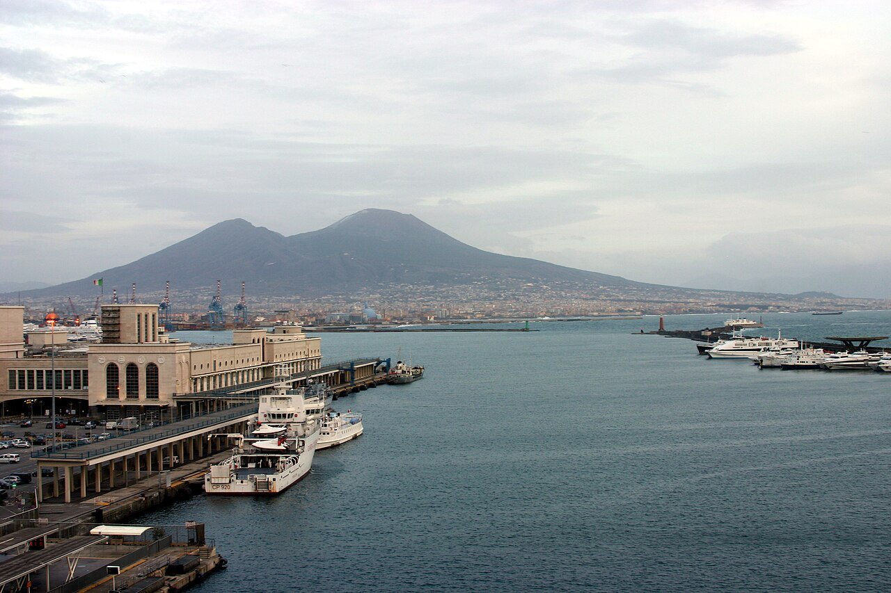 The port of Naples seen from Castel Nuovo, with ferries at the quay and the cone of Mount Vesuvius on the horizon