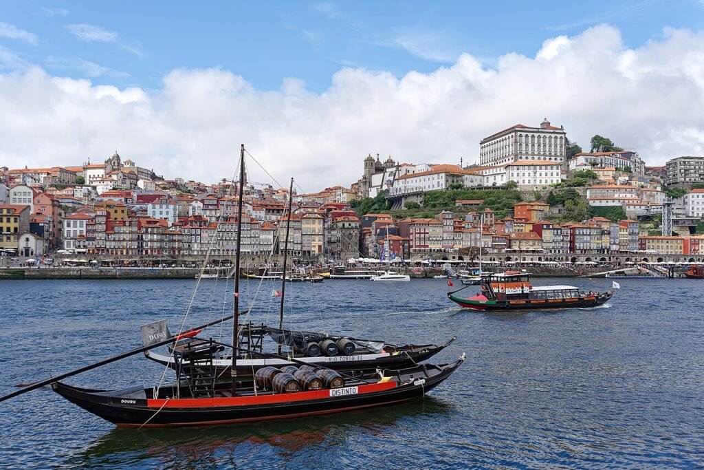 Traditional rabelo boats on the River Douro in front of the Ribeira district of Porto, seen from Vila Nova de Gaia, with Porto Cathedral above