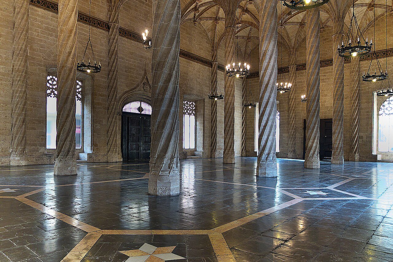 The Trading Hall of the Lonja de la Seda in Valencia: twisted stone columns rise to a ribbed Gothic vault above a polished floor