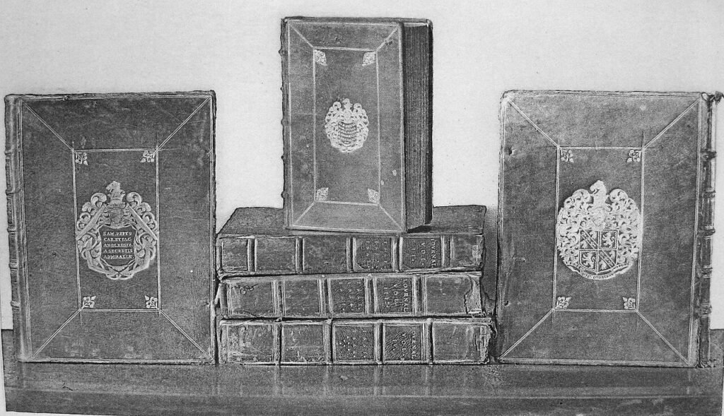 Black-and-white photograph of the leather-bound manuscript volumes of Samuel Pepys’s diary, stamped with his coat of arms