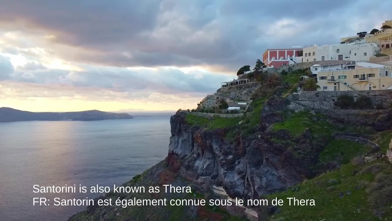 Santorini cliff with white houses above the caldera at dusk