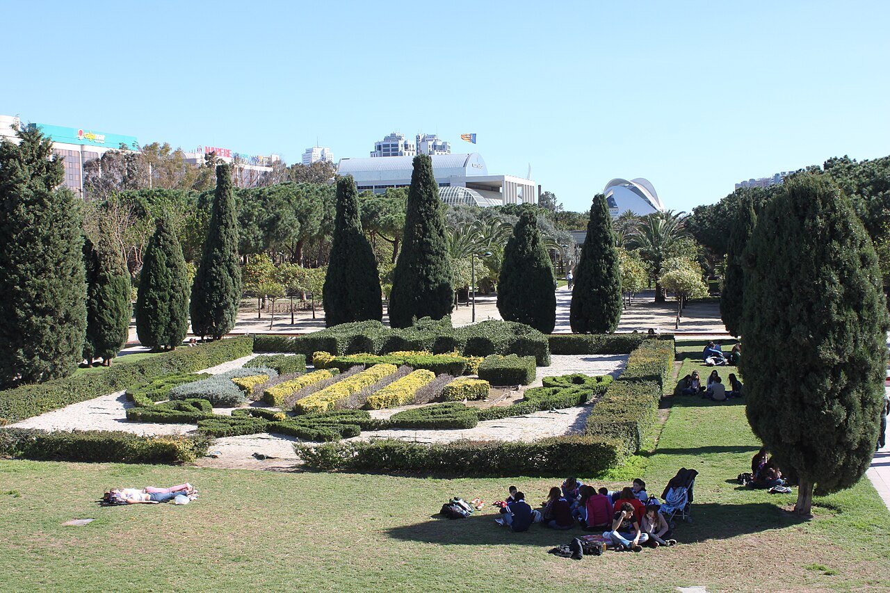 The Turia Garden in Valencia: lawns, clipped hedges and cypress trees in the old bed of the River Turia, with the City of Arts and Sciences in the distance