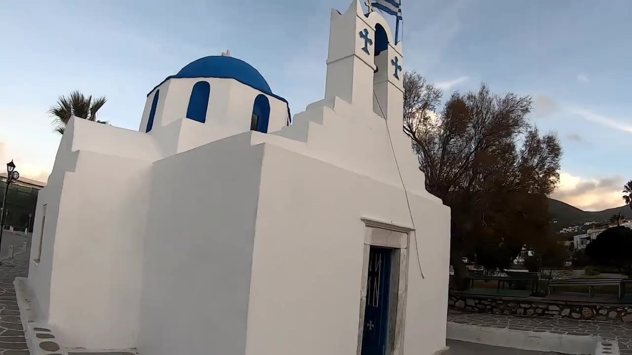 Whitewashed chapel with a blue dome on Paros island