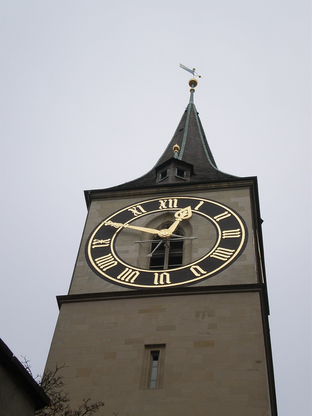 The tower of St Peter’s Church in Zurich with its large black and gold clock face